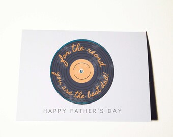 May include: A white card with a blue and black vinyl record illustration. The record has orange text that reads "for the record you are the best dad!" and the text "Happy Father's Day" is printed below the illustration.