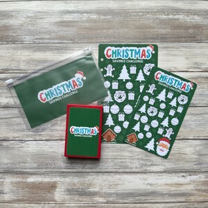 May include: A set of three green and red Christmas savings challenge trackers. Each tracker features a green background with white Christmas icons and the text "Christmas Savings Challenge".
