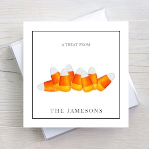 May include: A white card with a black border features a watercolor illustration of candy corn. The text "A TREAT FROM" and "THE JAMESONS" is printed in black. The card is inside a clear plastic sleeve.