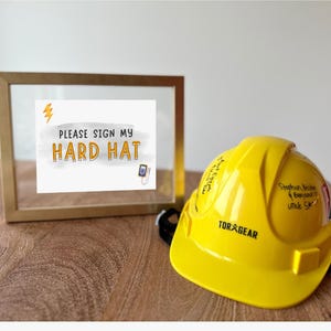 May include: A yellow hard hat with the text "TORXGEAR" and "Stephen Walker,  Benjamin & Uncle Sam" written on it. A sign in a gold frame reads "PLEASE SIGN MY HARD HAT".