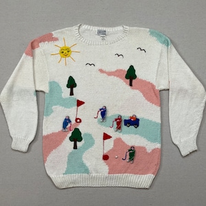 1990&#39;s, cotton, golf sweater in white with peach and aqua and colorful, 3D golfing ladies