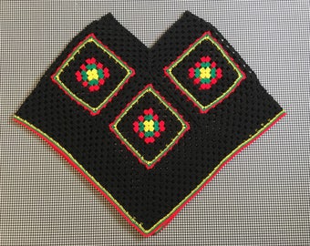 Hand crocheteed, afghan square, poncho, in black, with red, green, and yellow