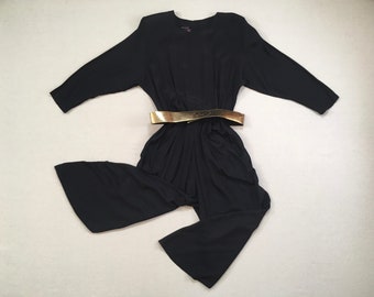 1980's, broad shoulder, button back, belted, balloon cut, dropped crotch, cropped leg, tulip cuff, romper in black with gold belt