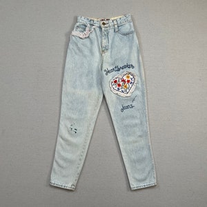 1980&#39;s, &quot;Heartbreaker jeans&quot; in light wash with embroidered floral, heart patch and eyelet lace trim