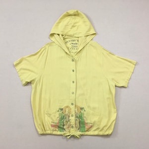 2000, linen/rayon blend, short sleeve, button front, hoodie in pale yellow with art deco images