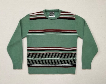 1970's, sweater in antique green with rust, black and white designs