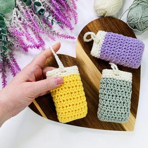 May include: A set of three ceramic mugs with a speckled, matte finish. The mugs are in shades of cream, light gray, and dark gray. Each mug has a simple, minimalist design and a rounded handle.