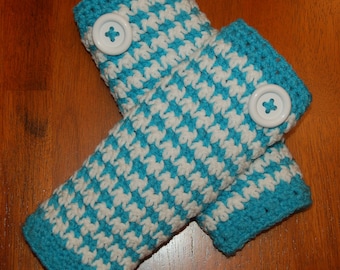 May include: A pair of blue and white crocheted arm warmers with white buttons.