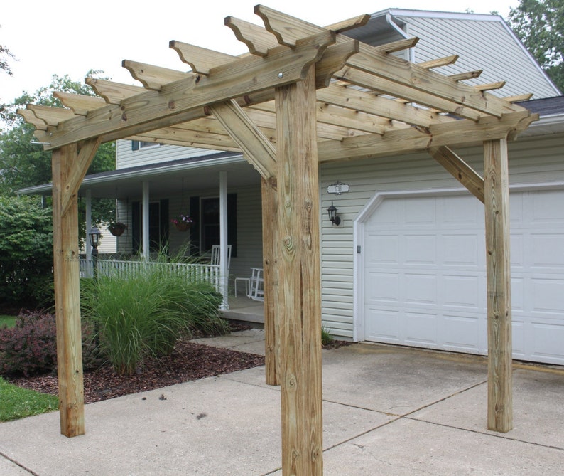 May include: A wooden pergola with a lattice top, providing shade and a decorative element for a home's exterior.