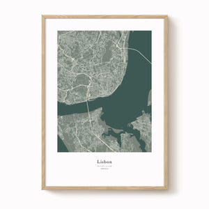 May include: A framed print featuring a detailed map of Lisbon, Portugal, in shades of gray and green. The city's layout is depicted with intricate road networks and geographical features. The word "Lisbon" is printed at the bottom.
