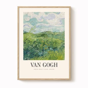 May include: A framed print of Van Gogh's "Green Wheat Fields, Auvers." The artwork shows a green field under a sky with blue and white clouds. The print is in a light-coloured wooden frame, with the artist's name and artwork title at the bottom.