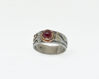silver and gold ring with ruby and black diamond