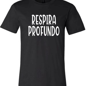 May include: Black t-shirt with white text that reads "Respira Profundo".