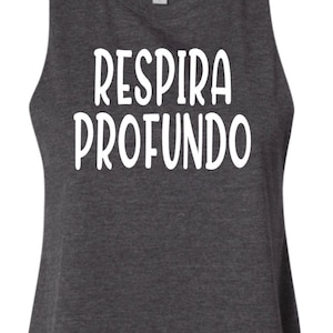 May include: A dark gray sleeveless crop top with the text "Respira Profundo" in white.
