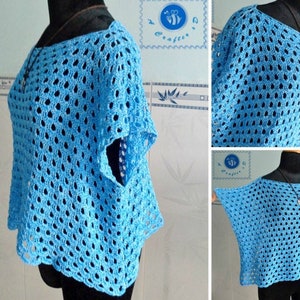 May include: A light blue crochet top with a pointed hem and short sleeves. The top is made with a lacy stitch pattern.