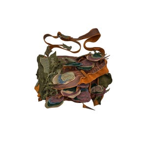 May include: A brown leather crossbody bag with a flap closure and a strap. The bag is decorated with colorful leather patches in shades of green, blue, purple, and orange.