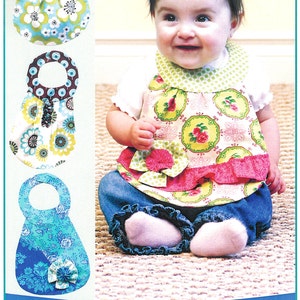 May include: A baby wearing a floral bib and jeans. The bib has a green and pink floral pattern. The image also shows three bib designs with floral patterns and the text "Beautiful Baby Bibs!" and "Diva Babies!"