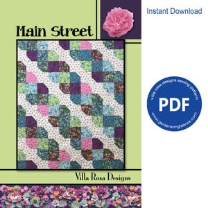 May include: A sewing pattern titled Main Street by Villa Rosa Designs featuring a quilt with a diagonal pattern of colorful fabric squares in shades of purple, blue, green, and pink with small animal prints, set against a light green background.