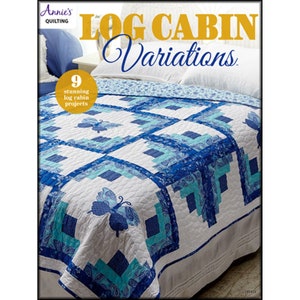 May include: A quilt with a Log Cabin design in shades of blue and white. The quilt features a butterfly applique and the text "Log Cabin Variations" and "9 stunning log cabin projects". The quilt is on a bed with white pillows.