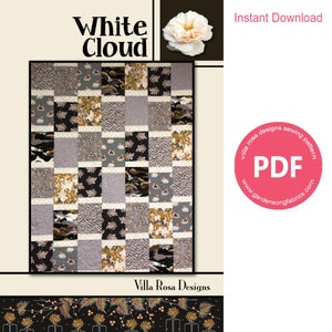 May include: A digital download PDF sewing pattern for a quilt called "White Cloud" by Villa Rosa Designs. The quilt features a patchwork design with various fabrics in shades of gray, black, white, and gold. The pattern is available for instant download.