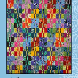 May include: A colorful quilt pattern called "Switch-A-Roo" designed by Sugar Pine Quilt Designs for Villa Rosa Designs. The quilt features a grid of squares with a variety of floral and geometric prints in bright colors like red, yellow, blue, green, and purple.