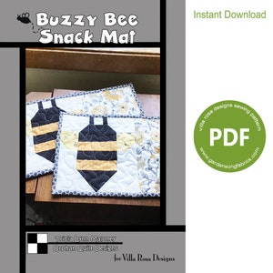 May include: A sewing pattern for a Buzzy Bee Snack Mat, featuring two bee-shaped placemats with black and yellow stripes, a white background, and a floral design. The pattern is available as an instant download in PDF format. The pattern is by Villa Rosa Designs and Orphan Quilt Designs.