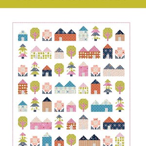 May include: A quilt pattern titled "Tiny Town Quilt" featuring a repeating pattern of colorful houses and trees. The design includes houses with various roof styles and trees in different shapes. The text "A Confident Beginner Quilt Pattern" is also included.