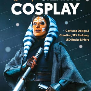 May include: A woman in a blue and white striped costume holds two lightsabers. The text "Level Up! CREATIVE COSPLAY" is at the top of the image. The text "Costume Design & Creation, SFX Makeup, LED Basics & More" is on the right side of the image. The text "Amanda Haas" is at the bottom of the image.