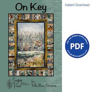 Könnte beinhalten: Ein digitaler Download eines PDF-Nähmusters für eine Quiltdecke mit dem Titel "On Key" von Villa Rosa Designs. Die Quiltdecke zeigt eine Hütte in einer Waldlandschaft mit einem Fluss im Vordergrund. Das Muster ist zum sofortigen Download auf Gardensongfabrics.com verfügbar.