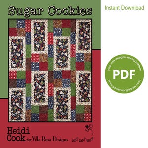 Può includere: Un modello di quilt scaricabile digitalmente chiamato "Sugar Cookies". Il quilt presenta un design a patchwork con tessuti rossi, verdi, blu e marroni. Il modello è di Heidi Cook per Villa Rosa Designs.
