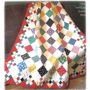 May include: A colorful quilt with a diamond patch design. The quilt features a red border and a pattern of squares in various colors, including red, yellow, green, and black. The text "Diamond Patch" is visible at the bottom of the image.