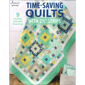 May include: A colorful quilt with a geometric pattern, featuring squares in shades of yellow, blue, and green. The quilt is made with 2.5-inch strips and has a white border with a teal edge. The cover of the book reads "Time-Saving Quilts with 2 1/2" Strips."