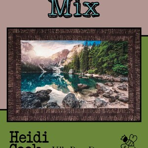 May include: A quilt featuring a scenic landscape with a lake and mountains, framed by a brown border. The text "Trail Mix" is at the top, with "Heidi Cook for Villa Rosa Designs" at the bottom. A bee and ants are also featured.