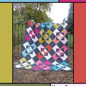 May include: A colorful quilt with a Dutch Windmills pattern, featuring a dark gray background and vibrant squares in pink, orange, yellow, and blue. The quilt is displayed outdoors, with text that reads "Dutch Windmills" and "Kate Griffin for Villa Rosa Designs."