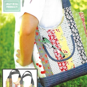 May include: A quilted tote bag featuring vertical strips of floral, polka dot, and text-patterned fabric in red, yellow, green, and black. The bag has dark blue denim straps and a bottom panel, with a front pocket holding black-rimmed glasses.