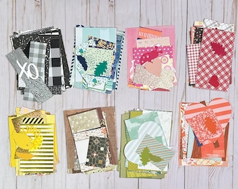 May include: Assortment of eight stacks of colorful patterned paper scraps, each stack containing various designs and textures. The papers are arranged in two rows of four stacks.