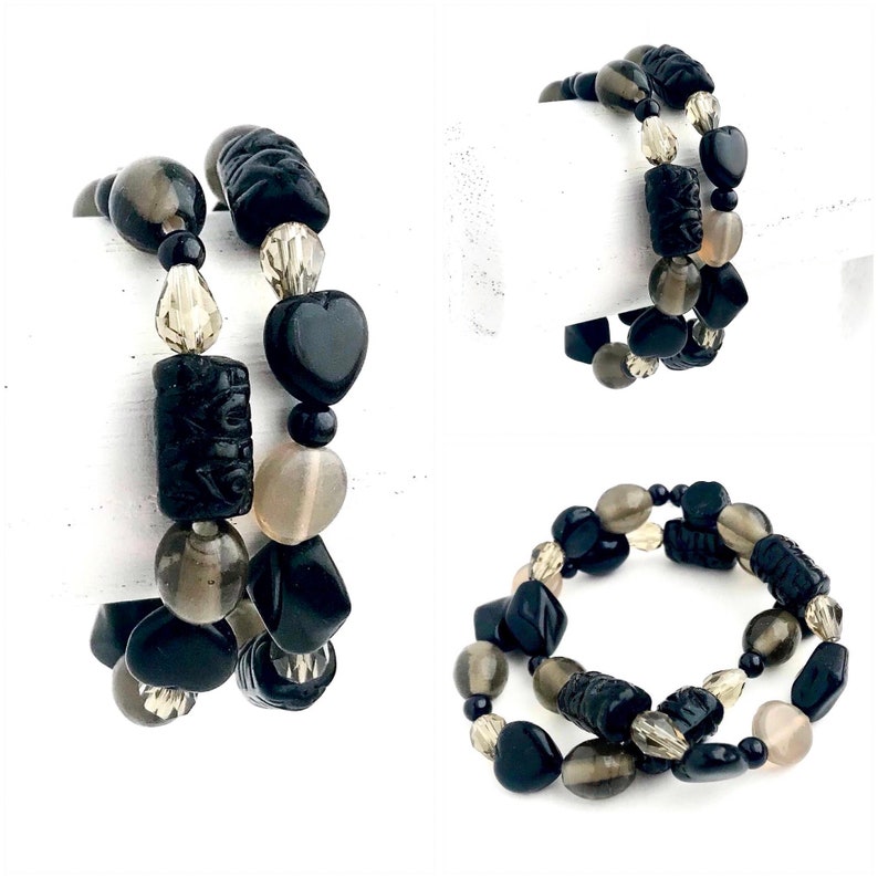 May include: Two black and gray beaded bracelets with various shapes, including hearts, squares, and round beads.