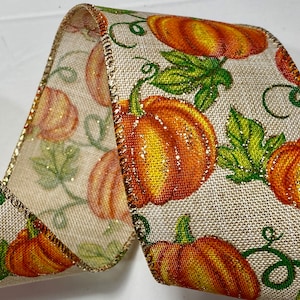 5 yards of 2 1/2 inch Pumpkins with accent Glitter Ribbon with a Wired Edge, Length is continuous up to 50 yards