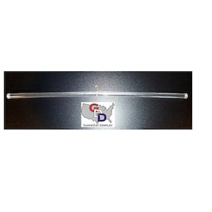 May include: A clear acrylic display rod with a metal hook at one end. The rod is approximately 12 inches long. The rod is designed to be used for displaying merchandise in a retail setting.