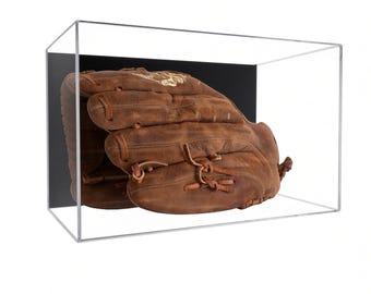 May include: A brown leather baseball glove is enclosed within a clear rectangular acrylic display case. The case features a solid black back panel, providing a high-contrast backdrop for the worn, textured surface of the baseball mitt inside.