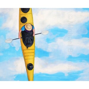 May include: A person in a blue shirt and straw hat paddles a yellow kayak on a bright blue sky with white clouds.