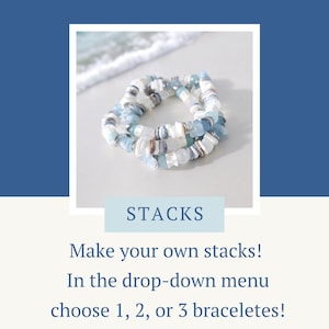 May include: Three beaded bracelets in shades of blue, white, and silver are stacked together. The bracelets are made of various shapes and sizes of beads. The word "STACKS" is in a light blue box. Text below says "Make your own stacks!"