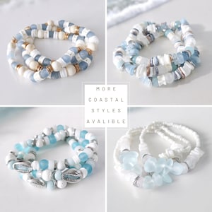 May include: Four stacks of coastal-themed bracelets. Each bracelet features a mix of white, blue, and gold beads, shells, and other decorative elements. The text "MORE COASTAL STYLES AVALIBLE" is visible in the center.