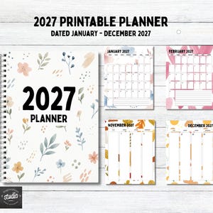 May include: A 2027 printable planner with a spiral binding and a white cover featuring watercolor floral illustrations. The text reads 2027 PLANNER. Included are sample monthly calendar pages for January, February, November, and December 2027.
