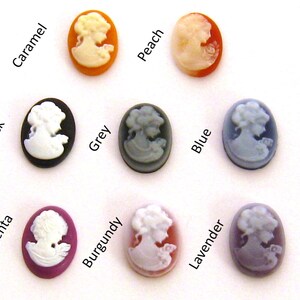 May include: Assortment of 10 cameo-style buttons in various colors, including black, grey, blue, lavender, burgundy, magenta, peach, caramel. Each button features a white cameo image of a woman.