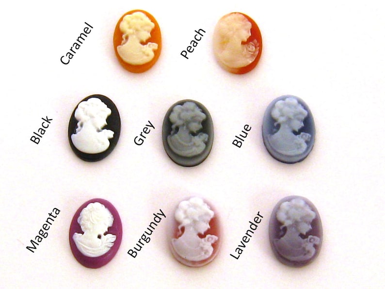 May include: Assortment of 10 cameo-style buttons in various colors, including black, grey, blue, lavender, burgundy, magenta, peach, caramel. Each button features a white cameo image of a woman.