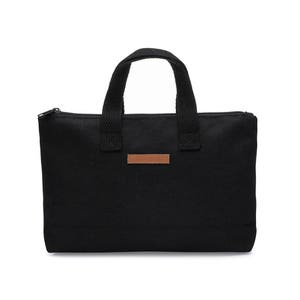 May include: Black canvas zippered tote bag with brown leather handles and a brown leather label that says "mamooq".