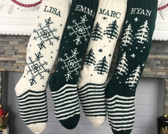 May include: Four green and white knitted Christmas stockings with names "Lisa", "Emma", "Marc", and "Ryan" embroidered on them. Each stocking features a different design: snowflakes, trees, and a combination of both.