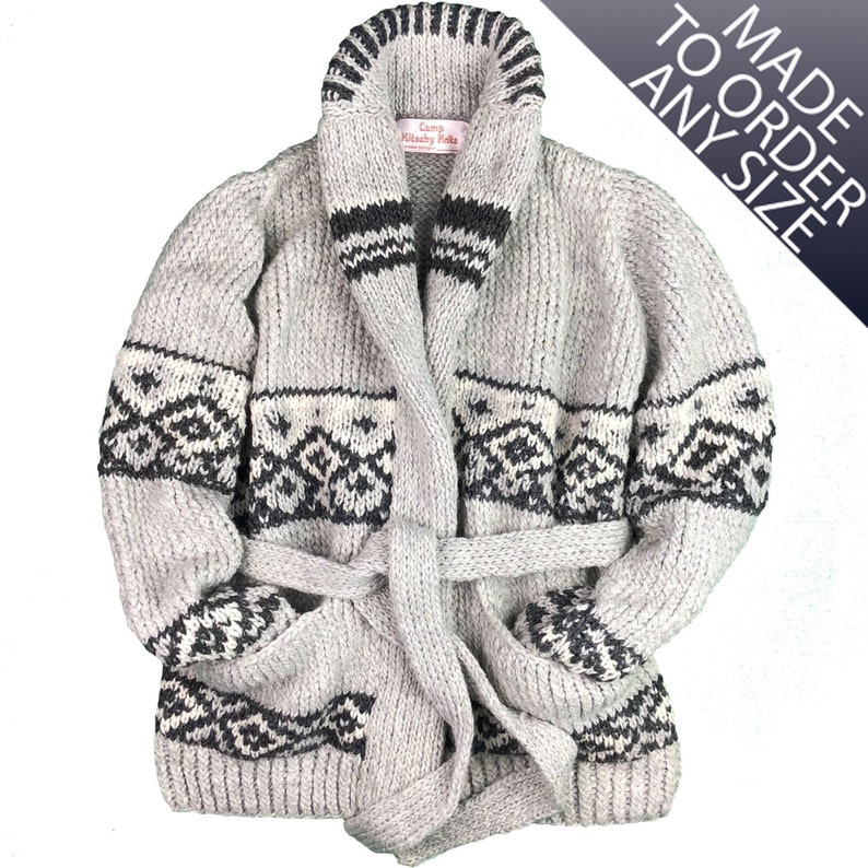 May include: A gray, chunky-knit cardigan with a shawl collar and a belt. The sweater features black and white geometric patterns on the pockets, sleeves, and collar. The text "MADE TO ORDER ANY SIZE" is visible.