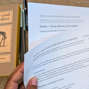 May include: A hardcover copy of "Pride and Prejudice" by Jane Austen is next to a story-building worksheet. The worksheet is titled "Pride & Prejudice Story Building Worksheet" and is designed to help writers create their own version of the classic novel.